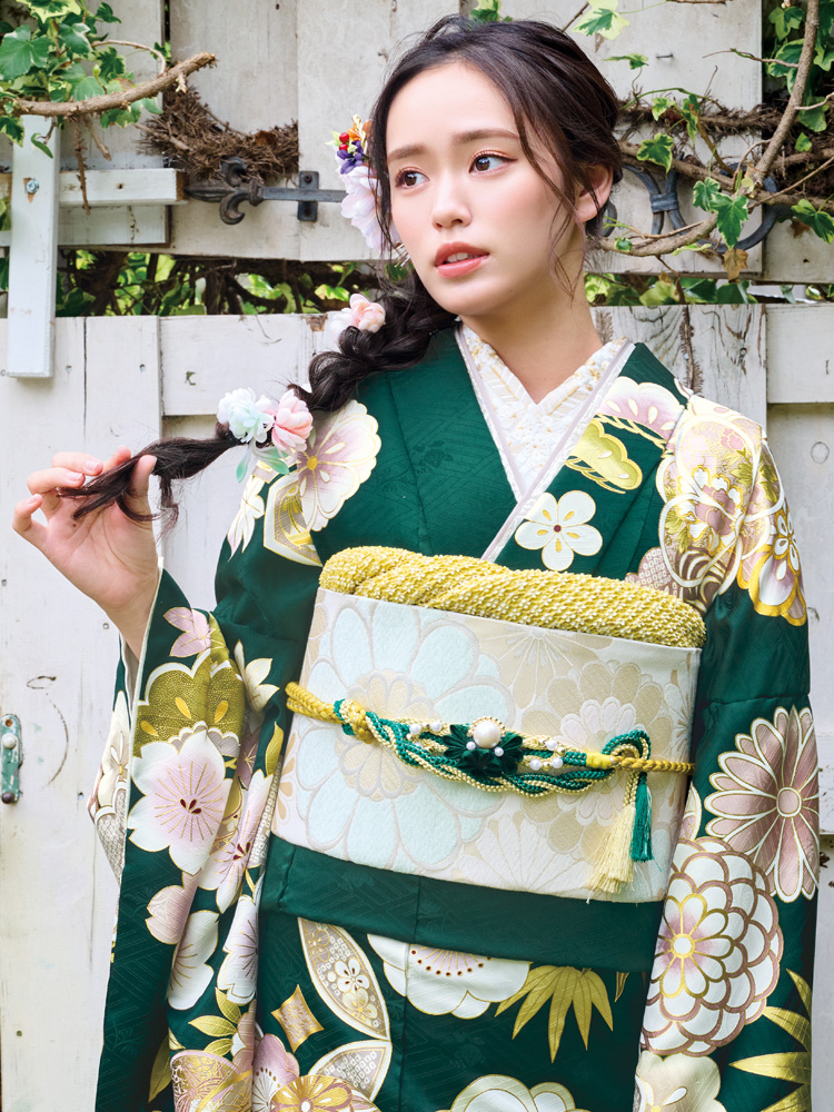 深緑の地色に淡い色彩の花々が咲き誇る、上品で可憐な振袖。